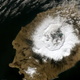 Satellite view of Okmok volcano in the Alaskan Aleutian Islands. The crater measures 6 miles (10 km) wide.